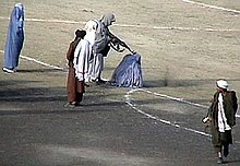 November 1999 public execution in Kabul of a mother of five who was found guilty of killing her husband with an axe while he slept. Taliban execute Zarmeena in Kabul in1999 RAWA.jpg