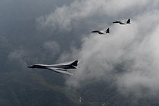 230px A U.S. Air Force B 1B Lancer is flanked by two F 15K Slam Eagles %2829942752785%29