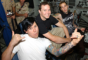 Left to right: Tom DeLonge, Mark Hoppus and Travis Barker visit US soldiers stationed in Manama, Bahrain in August 2003..