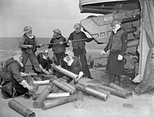 Gun crew of HMCS Algonquin during a naval bombardment of German positions at Normandy, prior to the D-Day landings. HMCS Algonquin 4.7 inch gun crew LAC 3223884.jpg