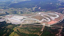 Istanbul Park is in a rural area and is paved with tarmac. It has large concrete and gravel run-off areas, large grandstands, and a substantial pit building and paddock.