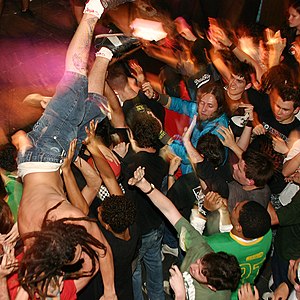 A man crowdsurfing in a moshpit, uploaded from...