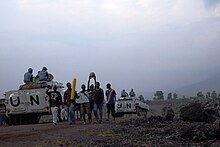 MONUSCO peacekeepers of the North Kivu brigade on patrol in a street of Goma pass a group of teenagers returning from a football game Photo of the Day, 08 January 2014.jpg