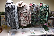 Examples of different US combat uniforms. From left to right are Army Combat Uniform in Universal Camouflage Pattern (UCP), Desert Battle Dress Uniform, Battle Dress Uniform and ERDL pattern Uniforms with four camouflage patterns - Fort Devens Museum - DSC07206.JPG