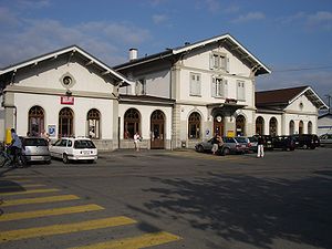 Three-story building with gabled roof and multiple wings