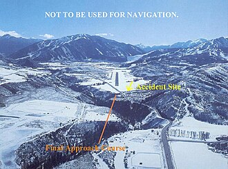 A daytime fair weather view of the approach to runway 15 at Aspen airport, depicting accident site of N303GA (NTSB report). AvjetAspen.jpg