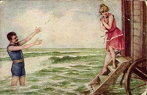 Man and woman in swimsuits, ca. 1910; she is e...