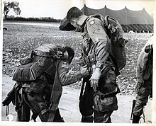 Members of the 508th PIR, 82nd Airborne Division, check their equipment before taking off from an airfield in Saltby, Leicestershire, England, to participate in the invasion of Europe, 1944. SC 320906 - Members of the 82nd Airborne Division, 508th Regiment, check their equipment before taking off from an airfield in Saltby, England, to participate in the invasion of Europe. (50068102941).jpg