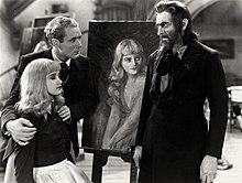 Barrymore, made up as Svengali, with a beard, staring intently at Marian Marsh, seated with her eyes closed peacefully, whose shoulders are being held defensively by Bramwell Fletcher, who looks concerned