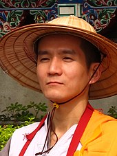 Taiwanese Buddhist monk with traditional robes and a bamboo hat Taiwanese Buddhist Monk Bamboo Hat Close.jpeg