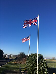 The flags of the United Kingdom and the United States at a World War II memorial in Upper Benefield, England UnionJackandOldGlory.jpg