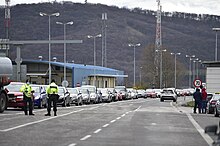 A queue of cars and trucks waiting to cross the Slovak border on 13 March Berg a DNV - 49655368166.jpg