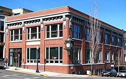 Photograph of the First National Bank of Hood River building, a two-story brick building on a city street corner