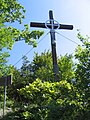 Eucharistic cross standing below top