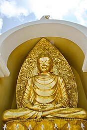 Statue of Buddha in the Darjeeling Peace Pagoda, India. This pagoda was designed by Japanese Buddhist monk Nichidatsu Fujii to unite people of all beliefs in their search for world peace. Statue of Buddha in Japanese Peace Pagoda,Darjeeling.jpg