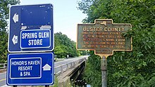 a picture of the marker with a creek that is the border behind it