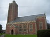 Краснокаменная церковь с квадратной башней.