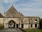 Abbey Gatehouse and adjoining Wall to East