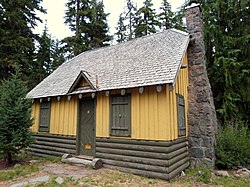 Photograph of a rustic building in a forest