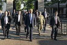 President Trump walking with an entourage to St. John's Episcopal Church for a photo op. Esper is pictured directly behind Trump. President Trump Visits St. John's Episcopal Church (49964153176).jpg