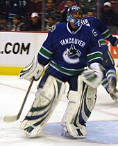 Roberto Luongo during the 2008-09 season, with a C visible on his goalie mask denoting his captaincy. He was named captain of the Canucks in September 2008. Roberto Luongo 03-2009.jpg