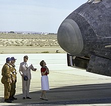"President Ronald Reagan chats with NASA astronauts Henry Hartsfield and Ken Mattingly on the runway as first lady Nancy Reagan inspects the nose of Space Shuttle Columbia following its Independence Day landing at Edwards Air Force Base on July 4, 1982." Ronald and Nancy Reagan NASA 1982.jpg