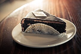 Tortenstück (Sachertorte), in Torten­spitze serviert