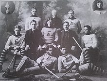 Black and white team photo with seven players dressed in uniform and three team officials dressed in suits