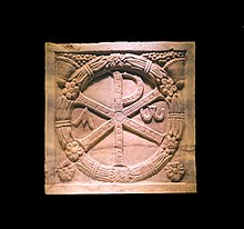 Monogramme of Christ (the Chi Rho) on a plaque of a marble sarcophagus, 4th century CE (Musei Vaticani, here in a temporary exhibition at the Colosseum in Rome, Italy) Chrisme Colosseum Rome Italy.jpg