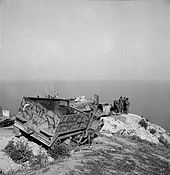 US troops with abandoned German equipment including an M3 halftrack May 1943 German M3 wreck2 Tunis May1943.jpg