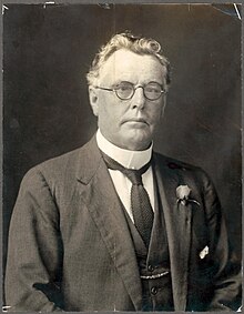 a black and white portrait of a man in formal dress