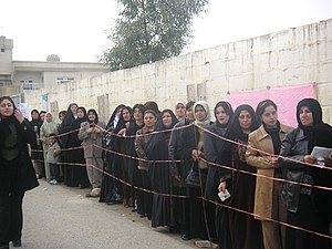 Segregated Iraqi women waiting to vote in elec...