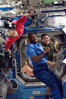 Leland D. Melvin and STS-122 mission specialists working on robotic equipment in the US lab S122e007776 orig.jpg