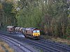 A Network Rail morning "leaf buster" train uses high-pressure water jets to clear fallen leaves from the line in 2009