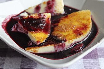 Colostrum pudding, an Icelandic dessert, with cinnamon sugar and a puréed blueberry sauce