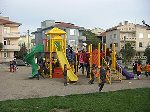 An overcrowded playground in a public garden f...