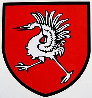 Grue blanche sur fond rouge, blason du district de la Gruyère