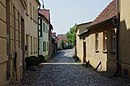 Sandoer Vorstadtsiedlung (geschützt sind Bauflucht und Straßenverlauf sowie Bauhöhe, Trauflinie, Hauptproportionen, Fensterform der Bauten)