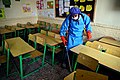Workers disinfect schools