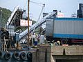 Loading blocks of factory-made ice from a truck to an "ice depot" boat