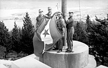German troops removing the Partisan flag in Split after taking the town from the Yugoslav Partisans who briefly captured it after Italy surrendered. Bundesarchiv Bild 101I-049-1553-31, Jugoslawien, Split, Flaggenwechsel.jpg