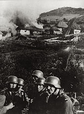 Germans set fire to a Serbian village near Kosovska Mitrovica. Burning village Serbia 1941.jpg