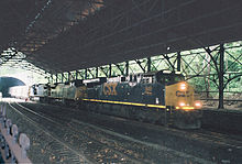 CSX freight train emerging from the north end of the Howard St. tunnel CSX train at Mt Royal Station.jpg