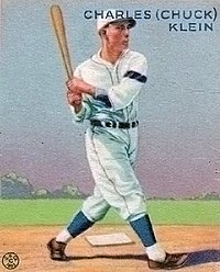 A baseball-card image of a man wearing a white baseball uniform and cap and swinging a baseball bat