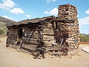 The Flying “V” Cabin was built in 1880 and was located in Canyon Creek, Young, Arizona. The cabin has notched gun ports which were used in July 17, 1882, during the Battle of Big Dry Wash, the last Apache War in that area. John D. Tewksbury Sr., of Pleasant Valley War fame lived here with his two wives and children.