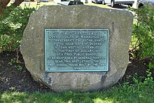 Stone plaque marking the site of the first public school in the United States, located in Dedham, Massachusetts Stone plaque marking the site of the first public school in America.JPG