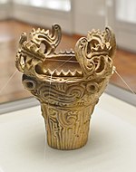 Vessel with flame-shaped ornamentation on the rim.