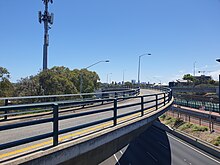 Curved concrete bus bridge over and down into a freeway