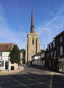 A stone church with a Gothic tower and a spire