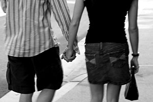 Opposite-sex couple holding hands
